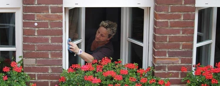 woman cleaning her apartment windows