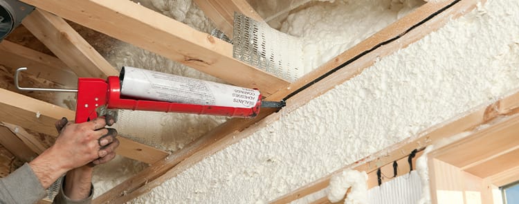 home insulation with caulk gun