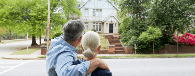 older couple looking at house exterior