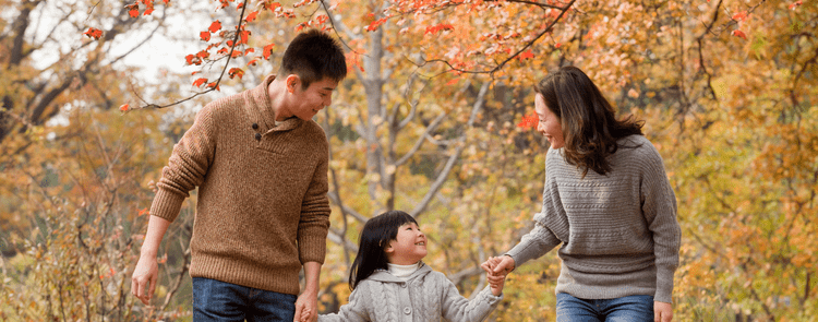 family playing outside in the fall.